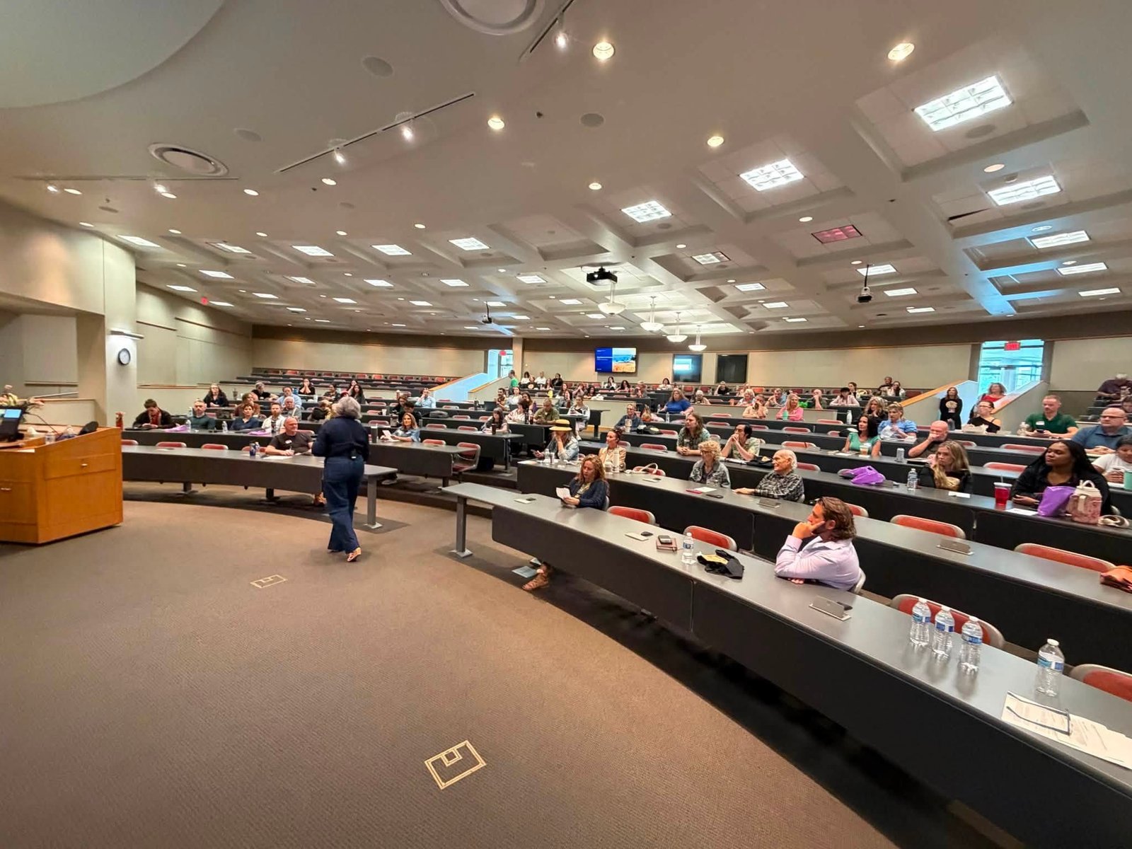 Open Plains 2026 conference attendees gathered in a lecture hall in Tulsa.